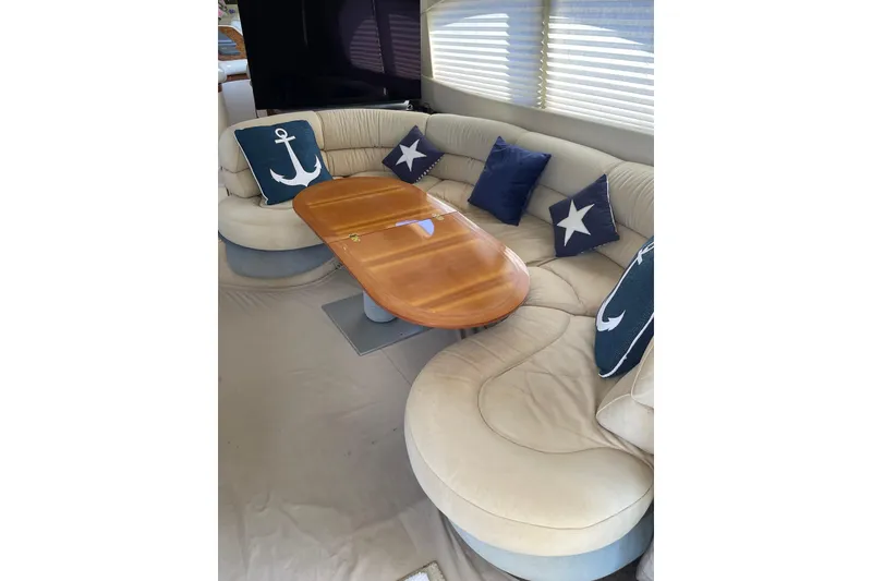 Slide: The Image of Luxurious interior of 2000 Azimut 46 Flybridge MY with elegant seating and nautical-themed cushions. - 65