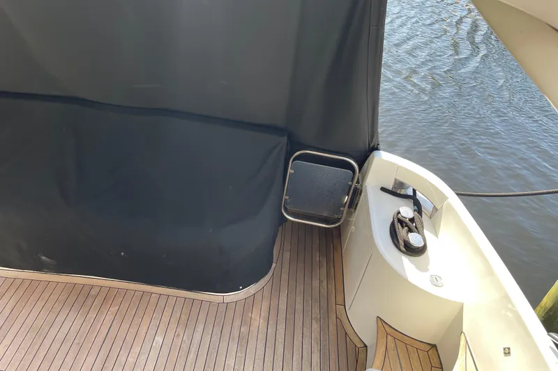 Slide: The Image of Azimut 46 Flybridge MY 2000 yacht deck with wooden flooring and water view. - 87