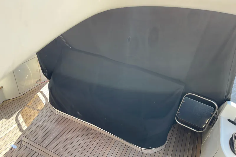 Slide: The Image of Azimut 46 Flybridge MY 2000 yacht with covered seating area and wooden deck. - 88