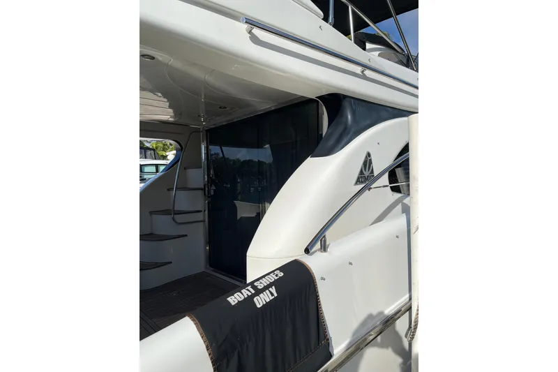 Slide: The Image of Azimut 46 Flybridge MY 2000 yacht with "Boat Shoes Only" sign on deck. - 9