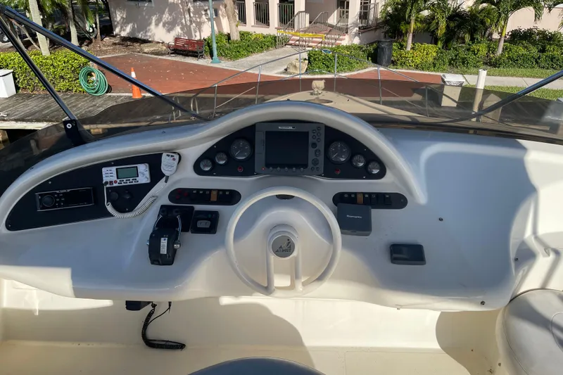 Slide: The Image of Control panel of a 2000 Azimut 46 Flybridge MY yacht, featuring navigation instruments. - 90
