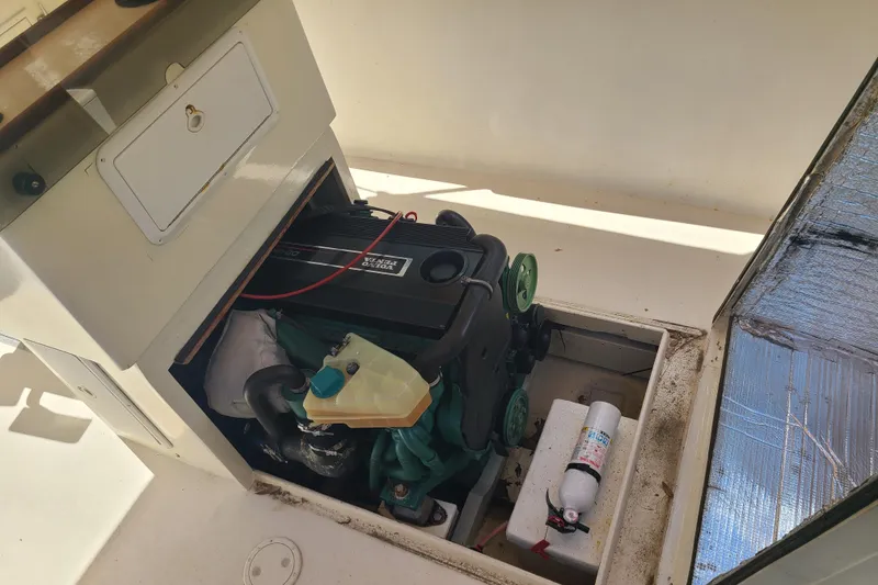 Slide: The Image of Engine compartment of a 1964 Holmes 25 Cuddy boat, featuring a Volvo Penta engine. - 11