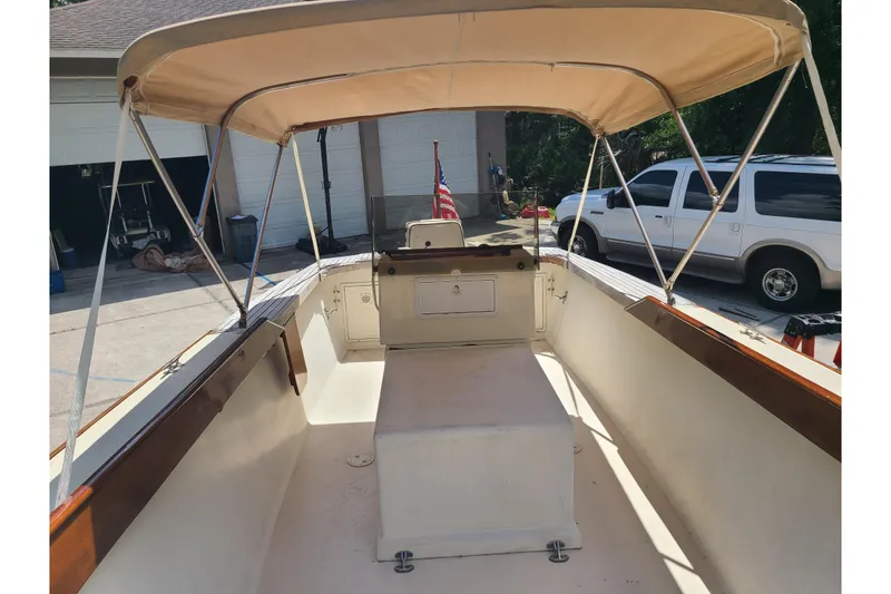 Slide: The Image of 1964 Holmes 25 Cuddy boat interior with canopy, parked in driveway. - 12