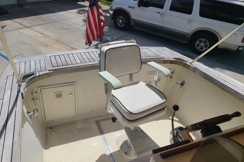 Slide: The Image of 1964 Holmes 25 Cuddy boat interior with captain's chair and American flag. - 13