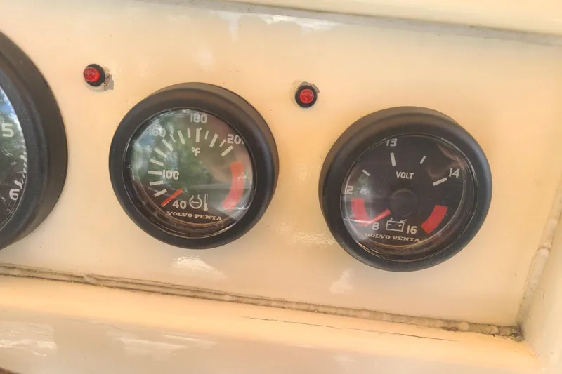 Slide: The Image of Dashboard gauges of a 1964 Holmes 25 Cuddy boat, featuring Volvo Penta instruments. - 15