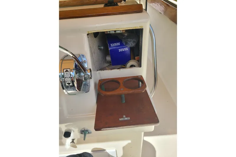 Slide: The Image of 1964 Holmes 25 Cuddy boat dashboard with controls and storage compartment. - 18