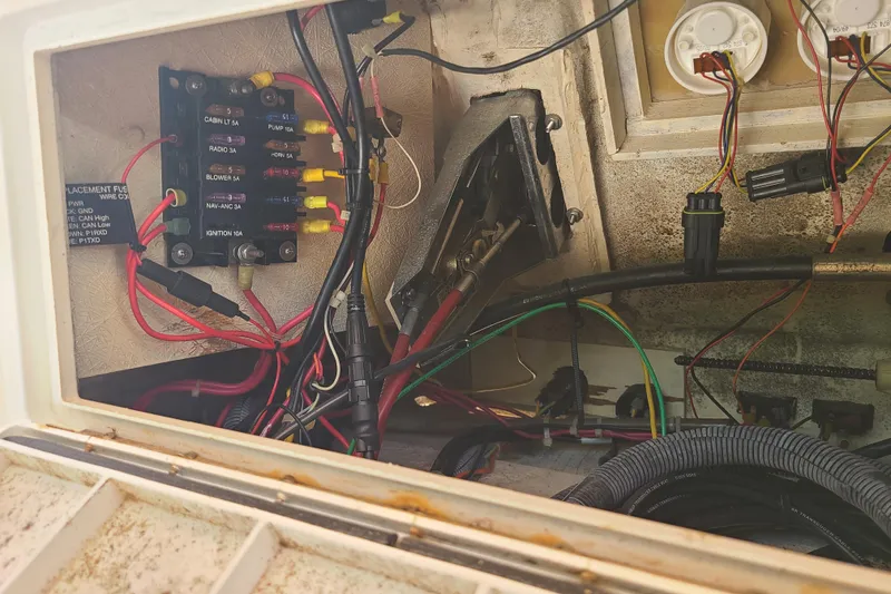 Slide: The Image of Electrical wiring and fuse panel inside a 1964 Holmes 25 Cuddy boat. - 19
