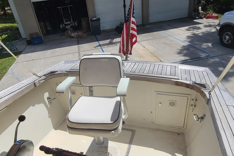 Slide: The Image of 1964 Holmes 25 Cuddy boat interior with captain's chair and American flag. - 20