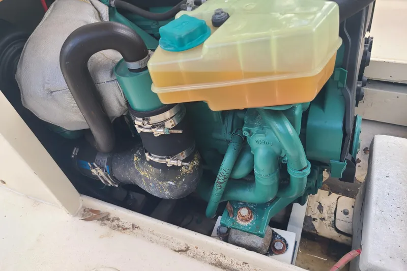 Slide: The Image of Engine compartment of a 1964 Holmes 25 Cuddy boat, showcasing mechanical components. - 25