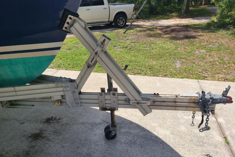 Slide: The Image of Trailer hitch of a 1964 Holmes 25 Cuddy boat on concrete driveway. - 29