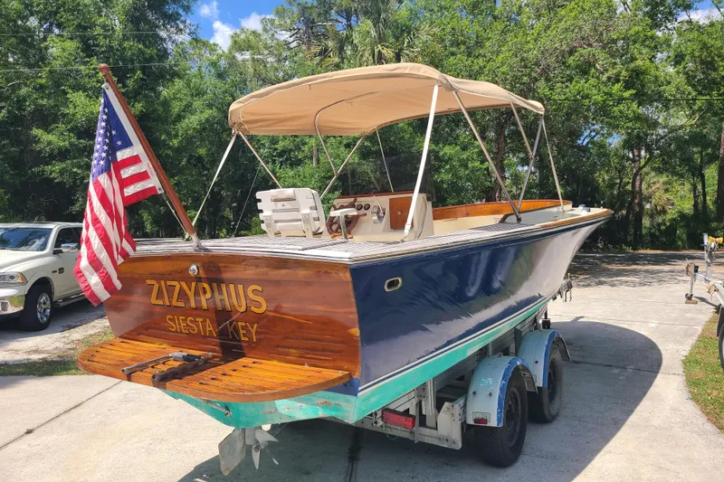 Slide: The Image of Vintage 1964 Holmes 25 Cuddy boat with American flag, named Zizyphus, on trailer. - 3