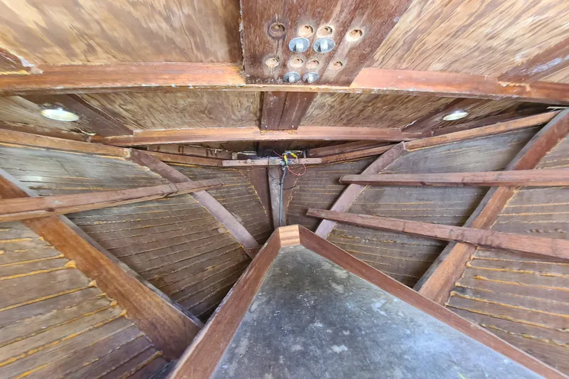 Slide: The Image of Interior view of 1964 Holmes 25 Cuddy boat, showcasing wooden structure and craftsmanship. - 30