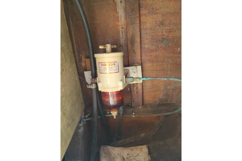Slide: The Image of Fuel filter system inside a 1964 Holmes 25 Cuddy boat, mounted on wooden panel. - 31