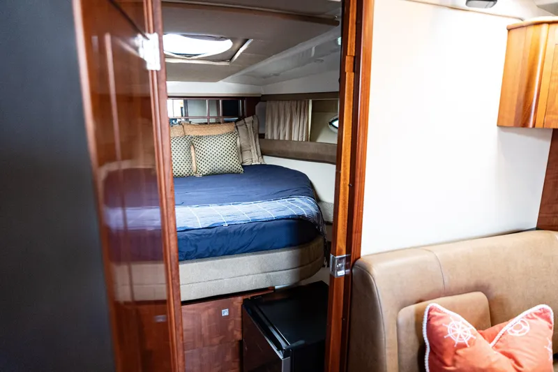 Slide: The Image of Luxurious interior of 2008 Monterey 400 Sport Yacht with cozy bed and elegant wood finishes. - 12