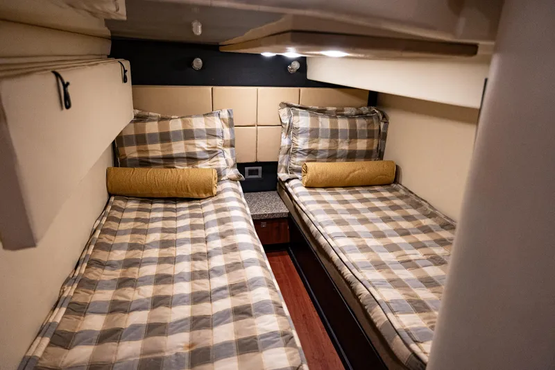 Slide: The Image of Interior cabin of 2008 Monterey 400 Sport Yacht with twin beds and plaid bedding. - 13