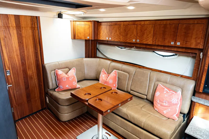 Slide: The Image of Luxurious interior of 2008 Monterey 400 Sport Yacht with plush seating and nautical-themed pillows. - 15