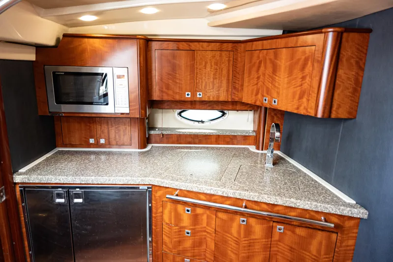 Slide: The Image of Luxurious 2008 Monterey 400 Sport Yacht kitchen with wood cabinetry and modern appliances. - 16