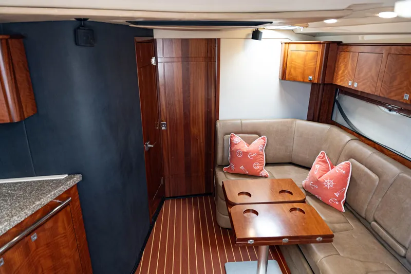 Slide: The Image of Interior of 2008 Monterey 400 Sport Yacht with wood accents and beige seating. - 18