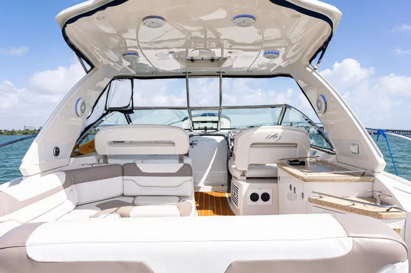 Slide: The Image of 2008 Monterey 400 Sport Yacht interior with seating and helm, under sunny skies. - 25