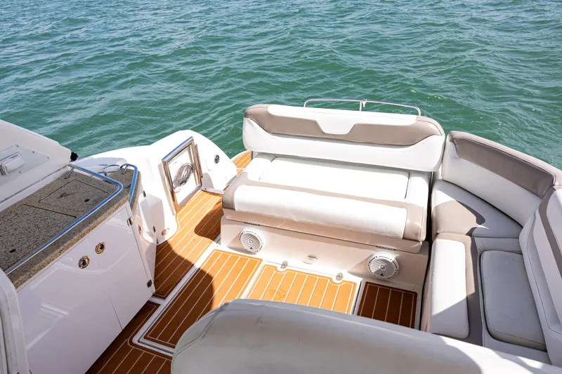 Slide: The Image of 2008 Monterey 400 Sport Yacht interior with cushioned seating and teak flooring on open water. - 31