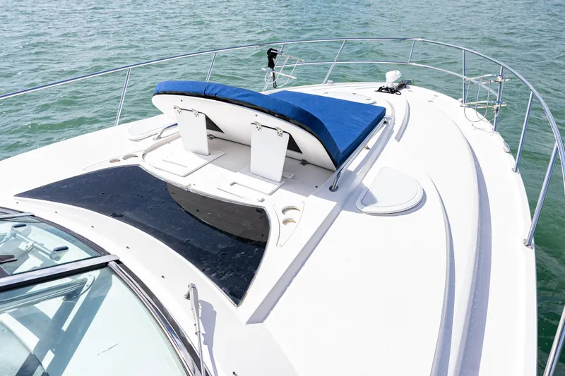 Slide: The Image of 2008 Monterey 400 Sport Yacht deck with blue sunpad, on calm water. - 33