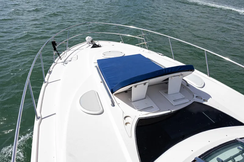 Slide: The Image of 2008 Monterey 400 Sport Yacht deck with blue sunpad on open water. - 36