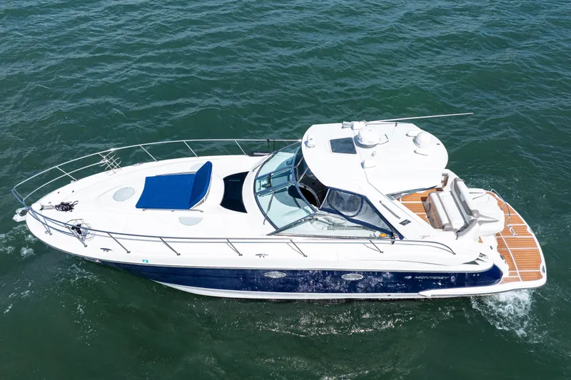 Slide: The Image of 2008 Monterey 400 Sport Yacht cruising on open water, showcasing sleek design and spacious deck. - 6