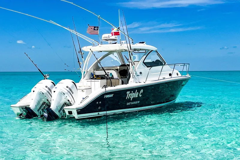 The Image of 2020 Pursuit OS 325 Offshore boat anchored in clear turquoise water. - 0