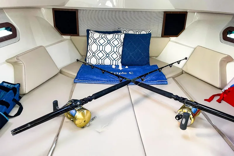 Slide: The Image of 2020 Pursuit OS 325 Offshore cabin with fishing rods and cushions. - 10