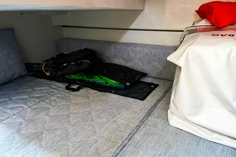 Slide: The Image of 2020 Pursuit OS 325 Offshore cabin interior with storage and bedding. - 12