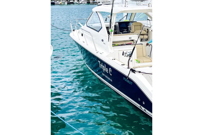 Slide: The Image of 2020 Pursuit OS 325 Offshore boat docked in clear blue water. - 15