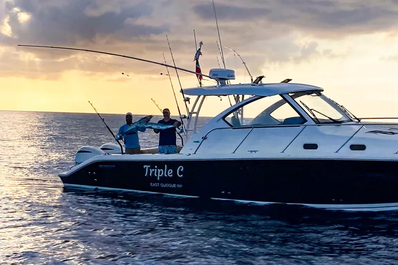 Slide: The Image of 2020 Pursuit OS 325 Offshore boat at sunset with two people fishing. - 19