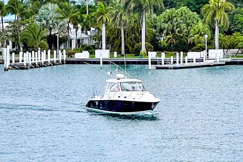 Slide: The Image of 2020 Pursuit OS 325 Offshore boat cruising near a tropical marina. - 20