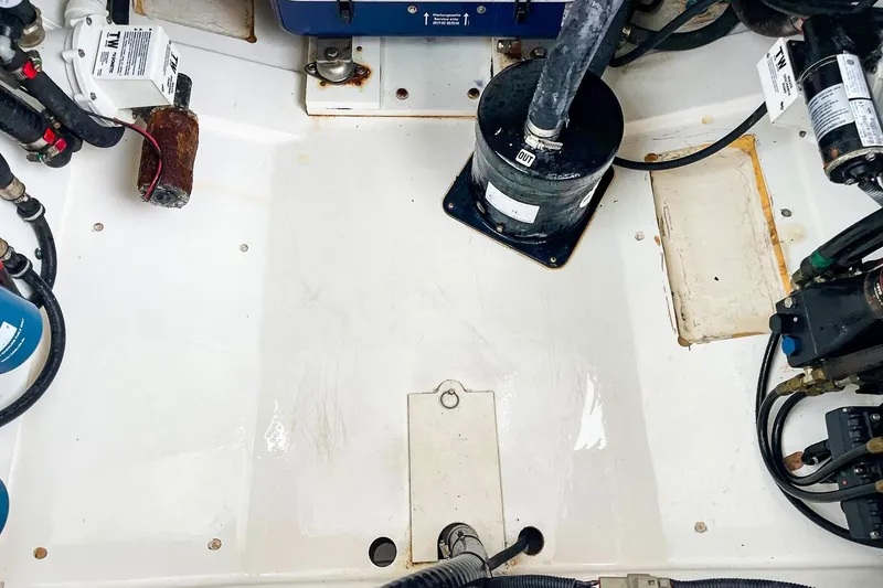 Slide: The Image of Engine compartment of a 2020 Pursuit OS 325 Offshore boat, showcasing mechanical components. - 21
