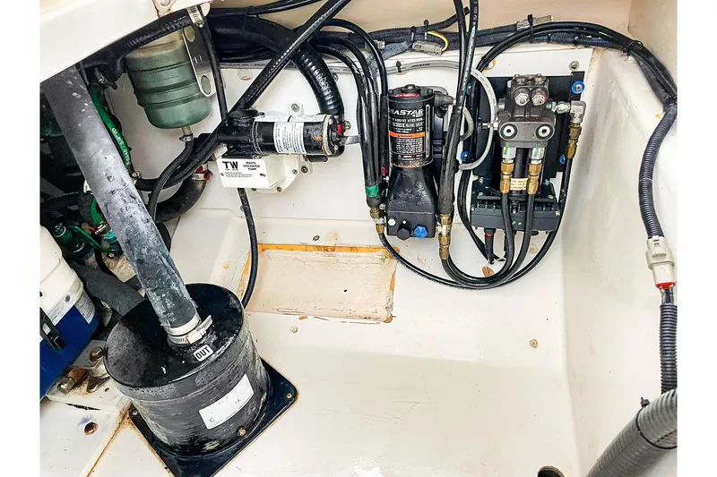 Slide: The Image of Engine compartment of a 2020 Pursuit OS 325 Offshore boat, showcasing mechanical components. - 22