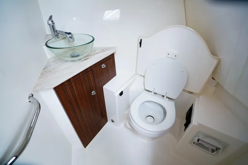 Slide: The Image of 2020 Pursuit OS 325 Offshore boat bathroom with modern sink and toilet. - 27