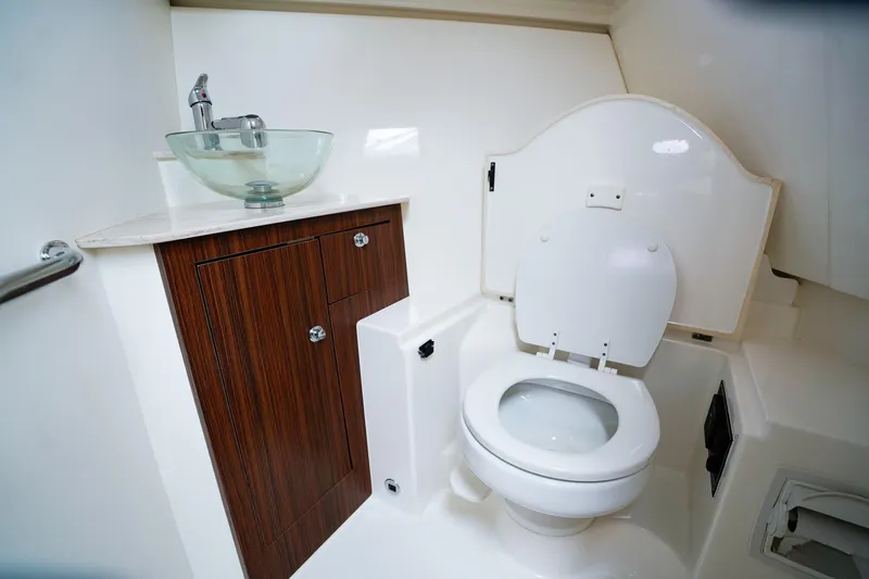 Slide: The Image of 2020 Pursuit OS 325 Offshore boat bathroom with modern sink and toilet. - 28