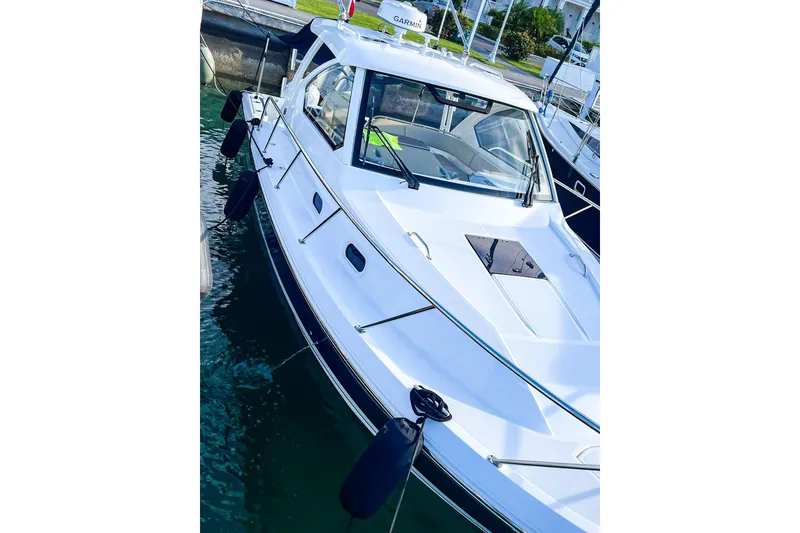 Slide: The Image of 2020 Pursuit OS 325 Offshore boat docked in marina, showcasing sleek design and modern features. - 3