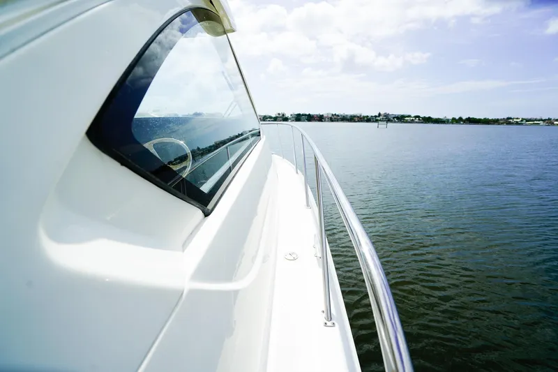Slide: The Image of 2020 Pursuit OS 325 Offshore yacht cruising on calm waters under a clear sky. - 35