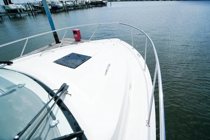 Slide: The Image of 2020 Pursuit OS 325 Offshore boat docked, showcasing sleek design and spacious deck. - 36
