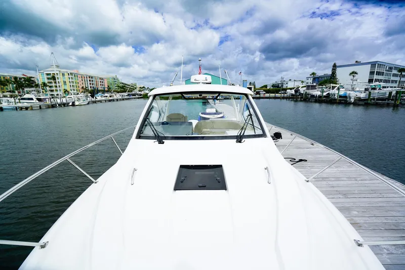 Slide: The Image of 2020 Pursuit OS 325 Offshore boat docked at marina under cloudy sky. - 37