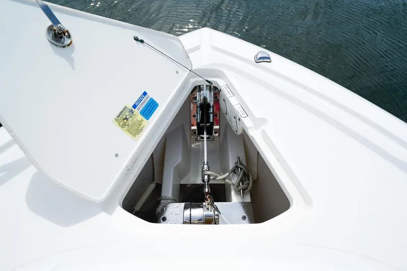 Slide: The Image of Anchor compartment of 2020 Pursuit OS 325 Offshore boat, open lid, visible ropes and mechanism. - 38