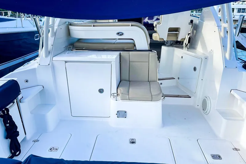 Slide: The Image of 2020 Pursuit OS 325 Offshore boat interior with seating and storage compartments. - 4
