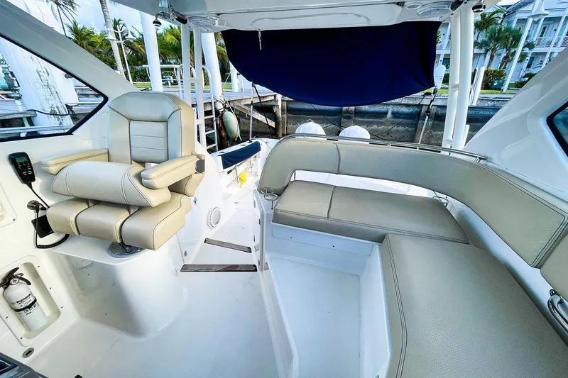 Slide: The Image of 2020 Pursuit OS 325 Offshore boat interior with beige seating and helm station. - 6