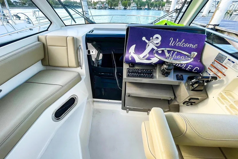 Slide: The Image of Interior of 2020 Pursuit OS 325 Offshore boat with helm and seating area. - 8