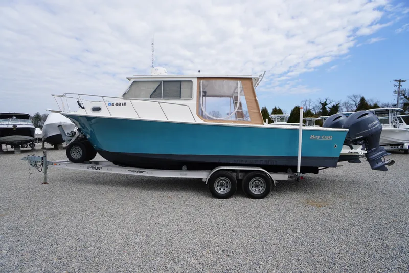 The Image of 2018 May-Craft 2700 Pilot XL boat on trailer, blue hull, dual outboard motors. - 0