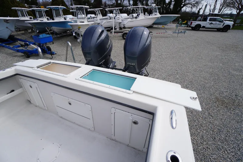 Slide: The Image of 2018 May-Craft 2700 Pilot XL boat with dual Yamaha 150 engines, docked on gravel. - 11