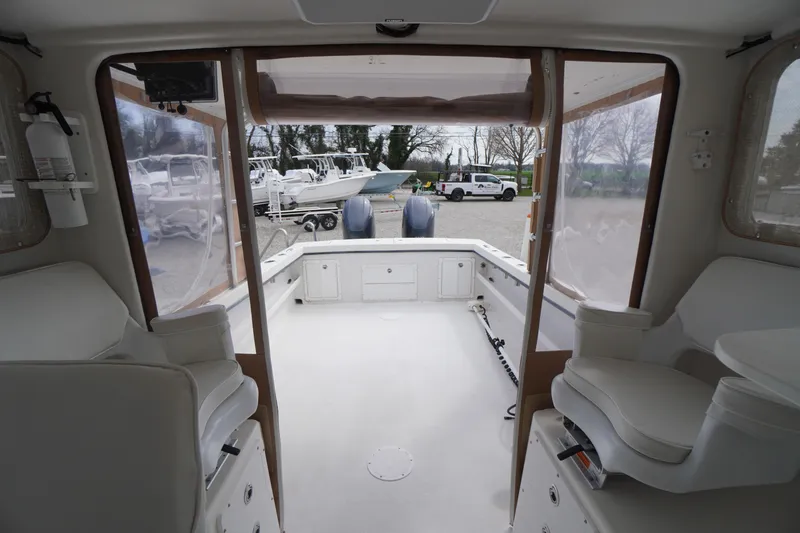 Slide: The Image of Interior view of 2018 May-Craft 2700 Pilot XL boat, showcasing seating and storage. - 14