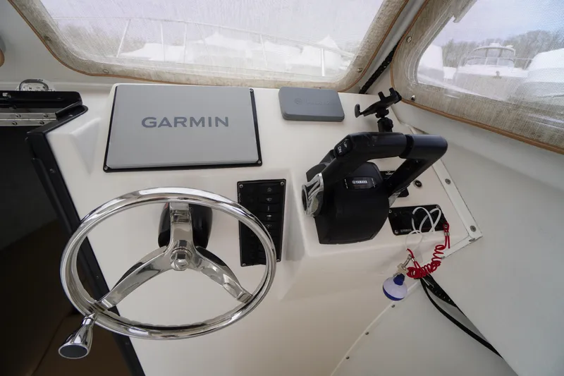 Slide: The Image of 2018 May-Craft 2700 Pilot XL helm with Garmin navigation and Yamaha controls. - 18