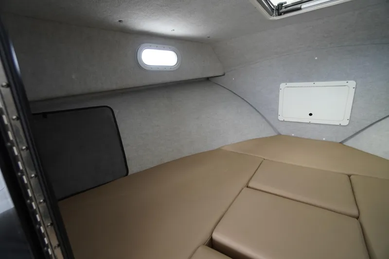 Slide: The Image of 2018 May-Craft 2700 Pilot XL cabin interior with beige cushions and small window. - 24